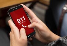 Person holding smartphone with 911 emergency call screen