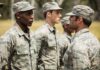 Military personnel standing in line outside during inspection