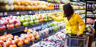 Woman shopping for fruit in a grocery store.