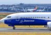 Boeing 737 800 on airport runway with other planes