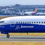 Boeing 737 800 on airport runway with other planes