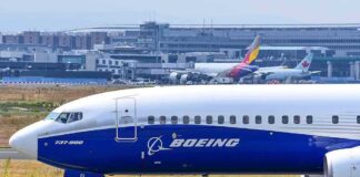 Boeing 737 800 on airport runway with other planes