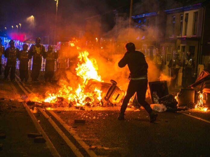 2501168827 featured image Street protest with fire and police presence at night