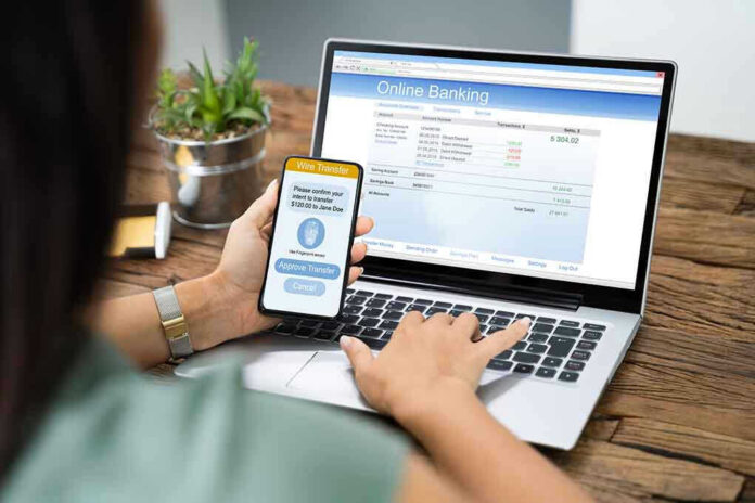 1542438851 Person using online banking on laptop and smartphone
