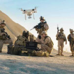 Soldiers operating a drone in a desert environment