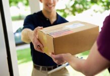 A delivery person handing a package to a customer at their doorstep