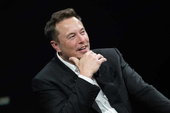 Man in suit smiling, resting chin on hand