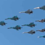 A formation of military jet fighters flying in a clear blue sky