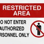 Sign indicating a restricted area with a prohibition symbol