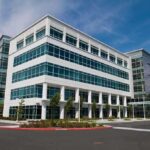 July Bloodshed Sparks Security Crackdown Modern office building with a glass facade and landscaped surroundings