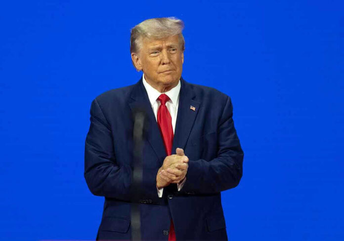 Man in a suit with a blue background.