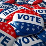 UNBELIEVABLE Endorsement Ignites Dem Civil War A pile of colorful buttons with the word VOTE and stars, symbolizing election participation