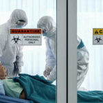 254 People QUARANTINED After Shocking Disease Surge Healthcare workers in protective gear in quarantine room.