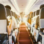 Airline Etiquette Sparks Mid-Air BRAWL: Who’s at Fault? Passengers seated inside an airplane cabin.