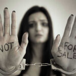 Massive Trafficking Sting Rocks San Diego Handcuffed woman shows NOT FOR SALE on her palms.