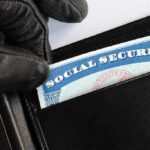 Billions Wasted on Dead People – Massive FRAUD Uncovered A gloved hand retrieving a social security card from a wallet