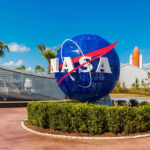 First Moon Mission in 50 Years Sparks Safety Firestorm NASA logo sculpture with spaceship and palm trees.