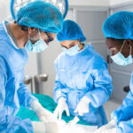 Male Cosmetic Surgery Surge Surprises Experts Surgeons performing an operation in a sterile environment.