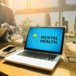 Parents Fight Back Against Child Psychiatric Medications Laptop displaying Mental Health screen in an office.