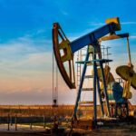 Venezuela-Iran Oil Flood: Market Mayhem Ahead An oil pump jack operating against a sunset backdrop