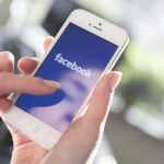 Police Bust Massive Facebook Car Theft Ring Person using the Facebook app on a smartphone