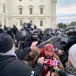 Capitol Riot Accountability – Politician Faces Consequences A tense standoff between protesters and police at a demonstration