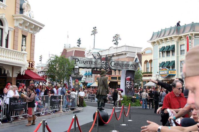 Crowd gathered at a Disney theme park for a Pirates of the Caribbean event