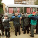 Violent Offenders Caught—Media Ignores ICE’s Victory Group of men with hands on their heads near a bus during a police operation