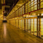 Epstein Death Videos EXPOSE Cover-Up—Government Hiding WHAT? Empty hallway between rows of prison cells.