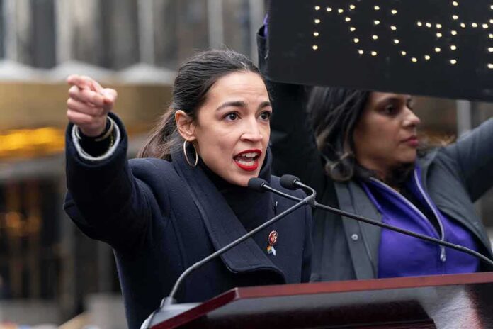 shutterstock_1289128096 (6).jpg A woman passionately speaking at a rally with a sign in the background