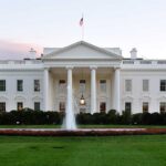Drug Lord Extradited Minutes Before White House Showdown The White House with a fountain in the foreground and an American flag flying