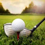 Tiger Woods Drops One-Word Masters Bombshell A golf ball on a tee with a golf club resting beside it on green grass