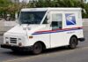 White USPS delivery truck parked on a street
