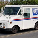 White USPS delivery truck parked on a street