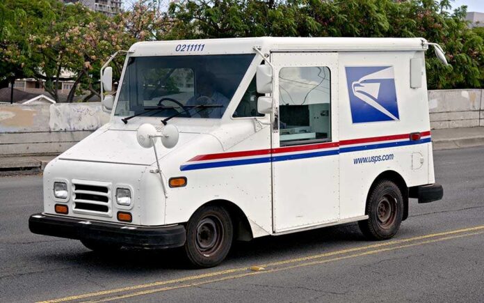shutterstock_172339019.jpg White USPS delivery truck parked on a street