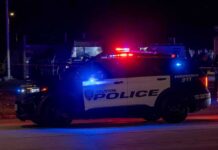 Houston police vehicle with emergency lights activated at night