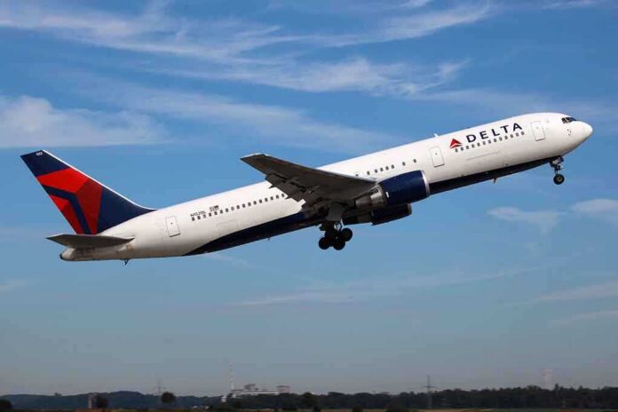 Delta Airlines airplane taking off against a blue sky