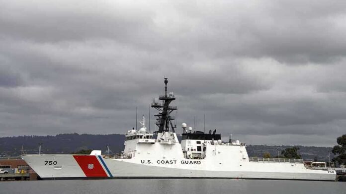 A U.S. Coast Guard ship docked under cloudy skies