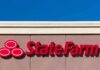State Farm logo displayed on a building against a blue sky