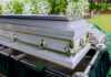 Long-Serving Congressman Passes Away Aged 86! White coffin with flowers in the background.