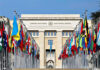 Israel Freezes UN Ties – Massive Fallout Looms United Nations building with numerous national flags outside.