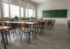 Teacher BEHEADED On Video! Empty classroom with desks, chairs, windows, and chalkboard.