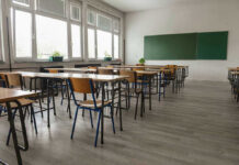 Teacher BEHEADED On Video! Empty classroom with desks, chairs, windows, and chalkboard.