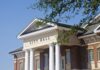 Shocking Scandal: Mayor’s Secret Ties to China Exposed Exterior view of a city hall building with columns and a clear blue sky