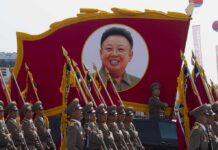 Kim’s Nuclear Power Lockdown: Terrifying Shift Military parade featuring soldiers and a large banner of Kim Il-sung