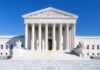 Supreme Court BOMBSHELL – Sides WITH Death Row Inmate! The Supreme Court building featuring marble columns and a clear blue sky