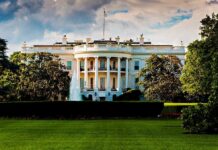 Undercover Tapes EXPOSE White House Staffer! The White House surrounded by greenery and a fountain in the foreground