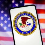 Department of Justice emblem displayed on a smartphone with an American flag background