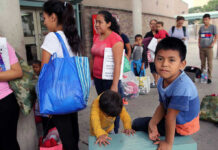 85,000 Kids Vanish — Disturbing Audio! People waiting outside carrying bags, boys sitting and playing.