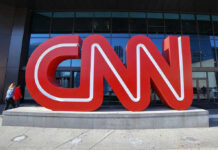 Dem Senator DESTROYS Colleague On CNN! Large red CNN sign outside building entrance.